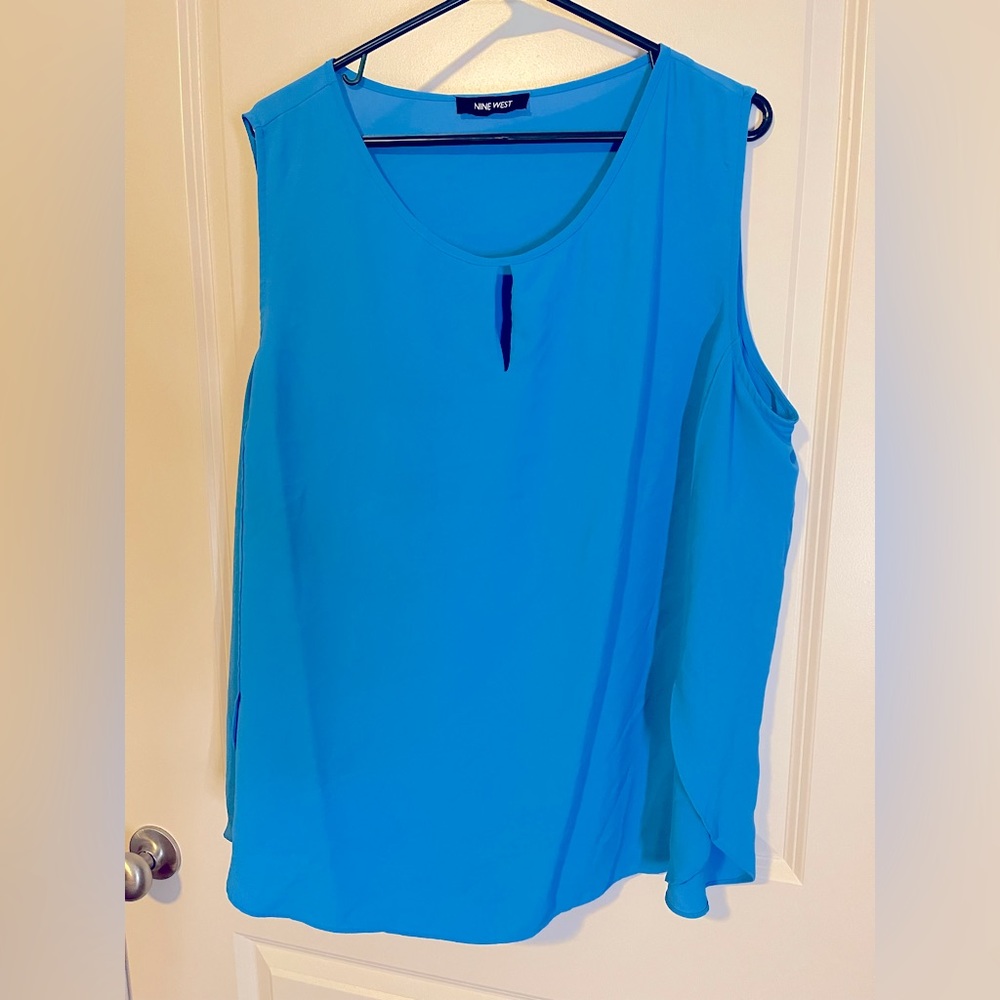 Blue Nine West sleeveless blouse with cutout.